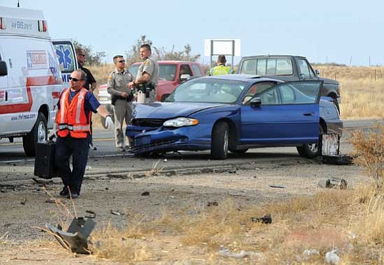 Matt Hinshaw/<br>The Daily Courier<br>
Emergency workers examine the scene of a two-vehicle accident on Highway 89 north of the Prescott airport Wednesday afternoon. A dump truck heading south on 89 blew a tire and crossed over into oncoming traffic. The second driver attempted to swerve out of the way but ended up colliding with the truck. The driver of the car was taken to the hospital with injuries and the truck driver was treated at the scene.