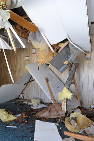 Les Stukenberg/The Daily Courier<p>
This home on Eagle Circle in Prescott suffered severe damage after a large tree fell on its roof during Monday night's storm.

