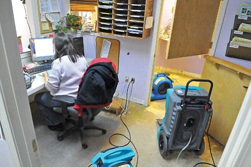 Matt Hinshaw/The Daily Courier<p>
Dianne Jacobson, the operations manager for Skyview Charter School, contacts parents asking for volunteers to help clean and repair the school.