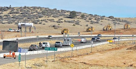 Matt Hinshaw/The Daily Courier<p>
Construction crews work 
near the intersection of 
Highway 89A and Side Road Tuesday afternoon in Prescott.
