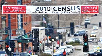 Matt Hinshaw/The Daily Courier<br/>A sign promoting participation in the U.S. Census hangs over Elks Hill in downtown Prescott Wednesday evening. City officials removed a similar census sign written in Spanish that was hanging about a block to the east.<br/>