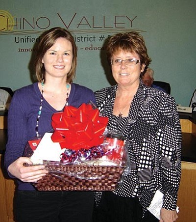 Courtesy photo<br/>Leanne Wellert (left), an eighth-grade mathematics teacher at Heritage Middle School who received Teacher of the Quarter honors from Chino Valley Unified School District, accepts the gift basket that goes with the award from Penny Hubble of State Farm Insurance, sponsor of the award.