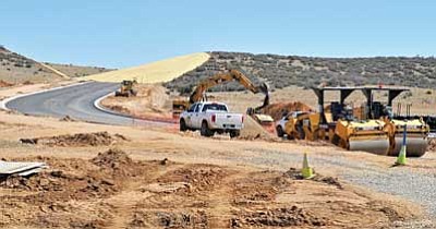 Matt Hinshaw/The Daily Courier<br/>Construction crews work on a part of the Centerpointe East Road near Side Road and the trailhead to the Peavine Trail Wednesday afternoon in Prescott.