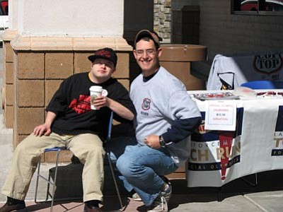 Officer Arlene Lucero, Prescott Valley Police Department/Courtesy photo<br/>William Allen, left, a Special Olympian, visits with NARTA recruit Nathan Dorfman at the Cop on Top event at Safeway on Saturday.