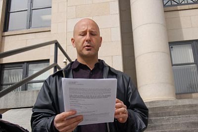 Ken Hedler/The Daily Courier<br />Michael Holevar announces postponements for two transactions during a trustee’s sale Monday morning on the steps of the Yavapai County Courthouse in Prescott.