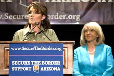 David Wallace, The Arizona Republic/The Associated Press<br>
Former Alaska Governor Sarah Palin speaks as Gov. Jan Brewer looks on at a news conference about border security in Phoenix on Saturday.


