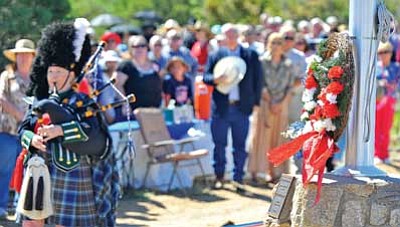 Matt Hinshaw/The Daily Courier<br>Bagpiper Denise Robinson plays "Amazing Grace" after Tori Atkinson from Prescott High School laid a wreath Monday morning during the Memorial Day ceremony at Citizens Cemetery in Prescott.