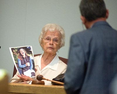 Les Stukenberg/The Daily Courier<br>Ruth Kennedy holds up a photo of her deceased daughter Carol Kennedy during questioning by Deputy County Attorney Joseph C. Butner III in the Steven Democker murder trial on Tuesday in Prescott.