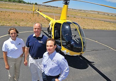 Matt Hinshaw/The Daily Courier<br>
From left, Jacquelin Maas, certified flight instructor with Universal Helicopters; David Hall, director of Embry-Riddle Aeronautical University’s Business and Finance department; and Gordon Jiroux, president of Universal Helicopters, stand next to a Robinson R22 training helicopter Thursday afternoon at the Prescott Airport.


