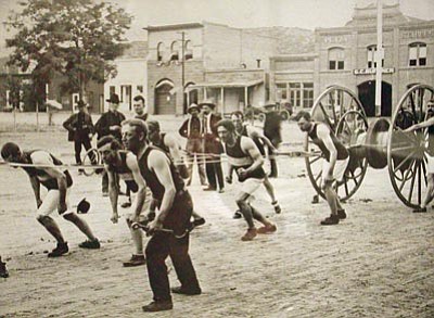 Courtesy Prescott Fire Department<br>
The Toughs Hose Company #1 pulls its hose cart north on Whiskey Row circa the late 1800s. Goodwin Street businesses sit in the background.
