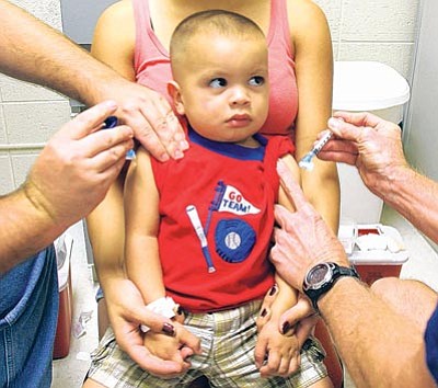 Darryl Webb/East Valley Tribune, AP<br>In this Aug. 27, 2009 photo, 1-year-old Aaron Hernandez II gets immunization shots Chandler CARE Center at San Marcos Elementary School in Chandler. Arizona children, ages 19 to 35 months, are "severely lagging behind" the federal recommendation to have 90 percent of them up to date on their immunizations, according to a report from the Arizona chapter of March of Dimes.
