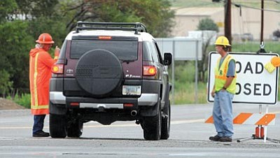 Brett Soldwedel/The Daily Courier<br>A road crew keeps cars off Highway 169 after a head-on collisions killed three YCSO detention officers.