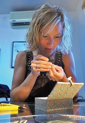 Matt Hinshaw/The Daily Courier<br>Karen Hayden, a master assayer with Aurum Strategies, inspects a gold piece of jewelry recently in Dewey-Humboldt.
