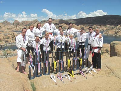 Submitted photo<br /><br /><!-- 1upcrlf2 -->Members of the Shinpu-Ren Family Karate team pose with trophies won at the USKC-PKC-USKK World Karate Championships in Dallas recently.<br /><br /><!-- 1upcrlf2 -->Top row: left to right - Sensei Alex Morris, Sensei Lori Morris, Sensei Amber Robinson, Alexander Randall, Tye Garcia, Sheri Pauly, Braden Balsley, Sensei Travis Roach, Kyoshi James Morris<br /><br /><!-- 1upcrlf2 -->Front row: left to right - <br /><br /><!-- 1upcrlf2 -->Trey Snyder, Fisher Plucinski, Adrianna Andrews, Ceily Plucinski<br /><br /><!-- 1upcrlf2 -->