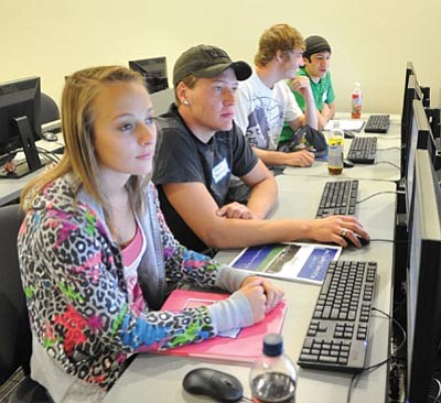 Les Stukenberg/The Daily Courier<br>Four of the 14 new freshmen at the NAU campus in Prescott Valley prepare to take a survey as part of an all-day orientation on Monday.
