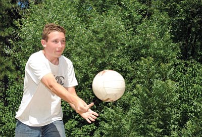 Brett Soldwedel/The Daily Courier<br>
Tyler Jensen, 16, serves up ‘Wilson’ during a volleyball game with several other NELA students at Camp Charles Pearlstein Aug. 26.

