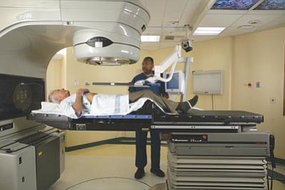 Calypso Medical/Courtesy photo<br>With the Calypso System, a prostate cancer patient lays flat on a table while the radiation therapist positions the machine to administer the treatments.
