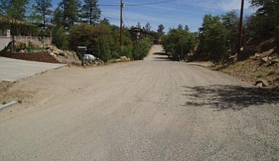 City of Prescott/Courtesy photos<br>
Manzanita Street in west Prescott was among the dirt streets to get a dust suppression membrane treatment this year. The before-and-after views show the condition of the dirt surface before city crews applied the mixture of milled asphalt and a tree-sap byproduct, topped by a chip seal.



