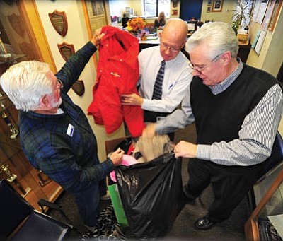 Les Stukenberg/The Daily Courier<br>
United Way of Yavapai County campaign executive Don Shaffer, Washington Traditional School Principal Harold Tenney and United Way of Yavapai County Executive Director Michael Whiting pick up donated coats as part of the United Way Coats for Kids program on Thursday.