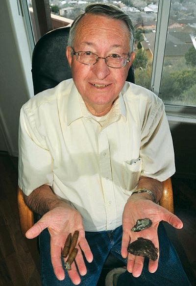Les Stukenberg/The Daily Courier<br>Prescott resident Bill Williamson holds up some shells he picked up from a school playground and shrapnel – one of which punctured their car during the attack on Pearl Harbor in 1941. Williamson was 8 years old and living on Oahu when the Japanese attacked Pearl Harbor.