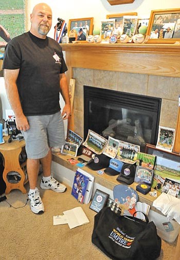 Matt Hinshaw/The Daily Courier<br /><br /><!-- 1upcrlf2 -->Little League umpire Mike Kincaid stands next to some memorabilia he collected while umpiring at the 2010 Little League World Series. Kincaid umpired 12 games while at the LLWS.<br /><br /><!-- 1upcrlf2 --><br /><br /><!-- 1upcrlf2 -->