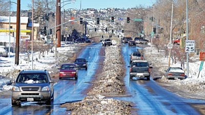 Matt Hinshaw/The Daily Courier<br>Drivers travel down Montezuma Street Saturday morning in Prescott. A winter storm hit the Prescott area Wednesday night, dropping between 6-9 inches of snow.