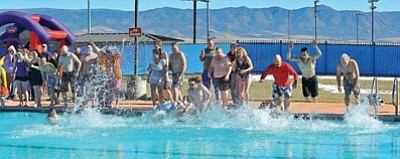 Matt Hinshaw/The Daily Courier<br>
Participants in the annual Prescott Valley Polar Bear Splash leap into the Mountain Valley Park Pool Saturday morning.