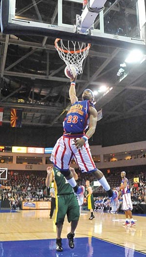Matt Hinshaw/The Daily Courier<br /><br /><!-- 1upcrlf2 -->The Harlem Globetrotters’ Bam Bam Bamiro, front, goes up for a slam dunk versus the Washington Generals at Tim’s Toyota Center in Prescott Valley on Friday.