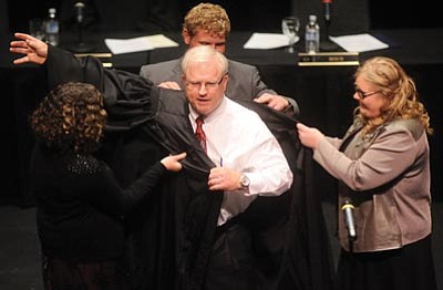 Les Stukenberg/The Daily Courier<br>Arizona Supreme Court Justice Robert Brutinel gets “robed” by his children during his investiture ceremony at the Yavapai College Performance Hall in Prescott on Friday.