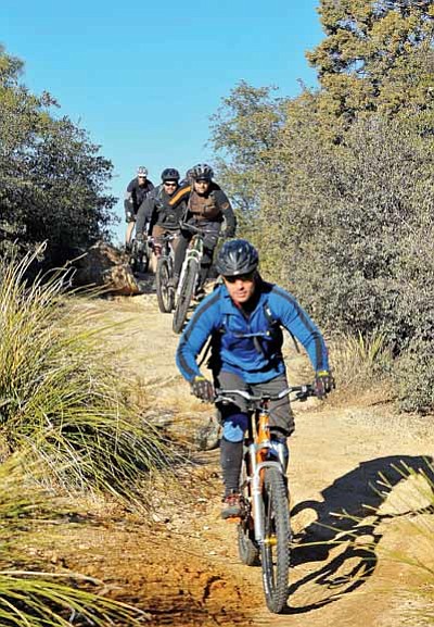 Matt Hinshaw/The Daily Courier<br>
Oryan Salberg leads a group of mountain bikers down the Willow Dells Trail in Prescott this past month.