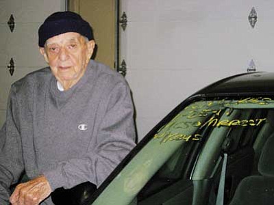 Erin Taylor/Kingman Daily Miner, AP<br>Louis Puskarov, 94, stands next to his 2005 Chevy Classic, which was impounded, in Kingman on Feb. 7. Puskarov was arrested last month by the Mohave County Sheriff’s Office and spent a night in jail over a warrant that should have been removed from the system a year ago.
