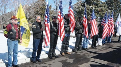 Les Stukenberg/The Daily Courier<br>
Members of the Patriot Guard Riders stand in a flagline at the memorial of WWII Army veteran Ben Cottone from Prescott at the National Cemetery on Monday.