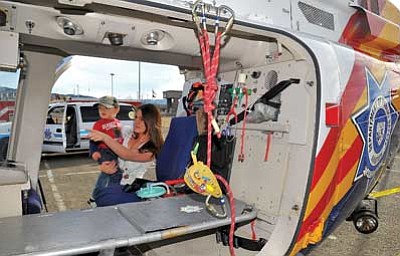 Matt Hinshaw/The Daily Courier<br>Stephanie Lamerson and her son Tony, 2, check out the inside of a Department of Public Safety Ranger air rescue helicopter from Phoenix Saturday afternoon during the Public Safety Day event at Tim's Toyota Center in Prescott Valley.