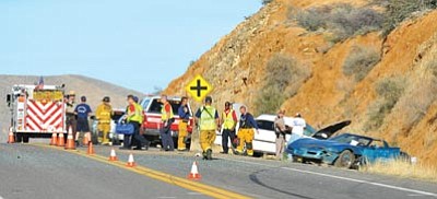 Matt Hinshaw/The Daily Courier<br>
Emergency workers begin to clean up the scene of a two vehicle collision on Highway 169 Wednesday afternoon in Dewey-Humboldt.  Both drivers of the two vehicles were transported by helicopter to hospitals in Phoenix.