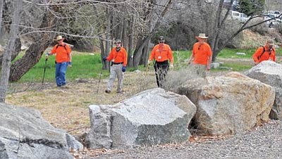 Matt Hinshaw/The Daily Courier<br>Members of the Yavapai County Sheriff's Office Search and Rescue volunteer Team sweep a creek for evidence near the area where a double homicide took place Friday evening in the Prescott Canyon Estates.
