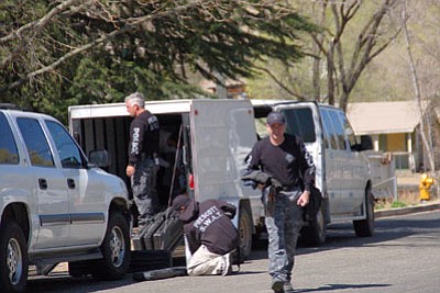 Lisa Irish/The Daily Courier<br>Prescott police pack up their gear Wednesday morning after a man allegedly brandished a handgun at a neighbor and then barricaded himself in his own trailer at the DownTown Trailer Park at 420 S. Montezuma St.