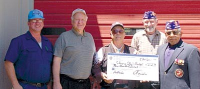 Lisa Irish/The Daily Courier<br /><br /><!-- 1upcrlf2 -->Dennis Spicknell, center, founder of the Shining Star program, accepts a check for $920 for the program’s battery fund at Budget Batteries in Prescott from Mike Brody, right,  and Alfonso Santillan Jr., far right, from the Military Order of the Purple Heart. Major John R. Tapia, PhD Chapter #608, far left, Richard Tobin, manager of Budget Batteries, and Bob Krause, owner of Budget Batteries, look on.