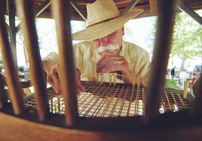Les Stukenberg/The Daily Courier<br>Dennis O’Reilly demonstrates the art of caning a chair during the 2010 Folk Arts Fair at Sharlot Hall Museum in Prescott. This year’s fair runs 10 a.m. to 5 p.m. Saturday and Sunday.