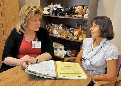Matt Hinshaw/The Daily Courier<br>Yavapai Regional Medical Center Family Resource Center Director Barbera Wisler-Waldock talks Friday afternoon in Prescott Valley with Family Support Specialist Sandy Cordova about a recent visit she had with a family.