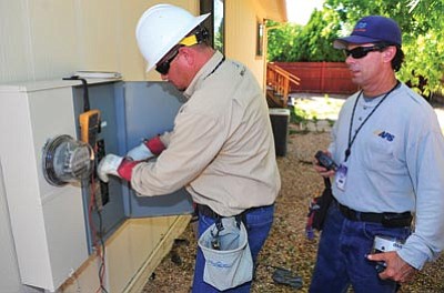 Les Stukenberg/The Daily Courier<br /><br /><!-- 1upcrlf2 -->APS employees change a standard meter to a "smart" meter at a home in the Prescott Country Club area of Dewey-Humboldt on Tuesday.