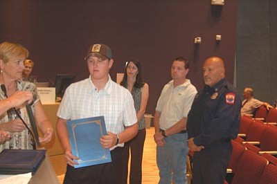 Ken HedlerThe Daily Courier<br /><br /><!-- 1upcrlf2 -->Prescott Valley Vice Mayor Patty Lasker, from left, presents a Lifesaving Award Thursday night to Jake Bassett as the three other recipients, Sherri Stanley, James Gentry and Al Camacho, look on. Interim Police Chief Bill Fessler credits the four award recipients with saving the life of Colin MacDiarmid after his motorcycle collided with a sport utility vehicle and exploded in flames April 27.
