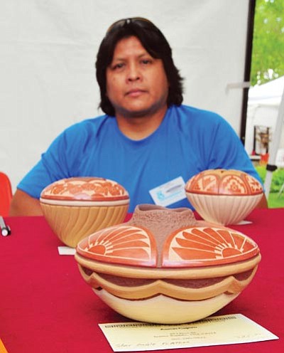 Les Stukenberg/The Daily Courier<br>Aaron Cajero displays his Jemez Pueblo sculptures at the 14th annual Indian Art Market at Sharlot Hall Museum on Saturday. The market features 100 different Native American artists and continues through today.