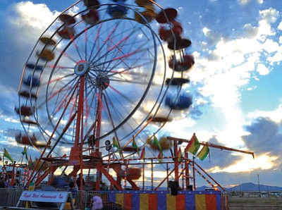 Matt Hinshaw/The Daily Courier<br>
The ferris wheel spins during the opening day of the County Fair Sept. 30, 2010, in Prescott Valley.