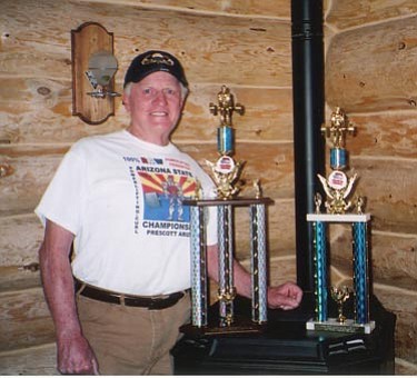 Courtesy Photos<br /><br /><!-- 1upcrlf2 -->Joe Weissenburger stands next to his power-lifting trophies.