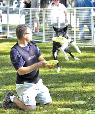 The Daily Courier/file<br>Brian Heuett demonstrates disk-catching with his dog Hope at a past Dogtoberfest on the courthouse plaza in Prescott.