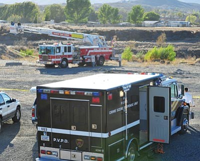 Les Stukenberg/The Daily Courier<br>Prescott Valley police and Central Yavapai firefighters look for evidence around the scene where the body of Robert Mendoza Celaya was found Thursday afternoon in the Agua Fria riverbed near the intersection of Coldwater and Bennett lanes in Prescott Valley.