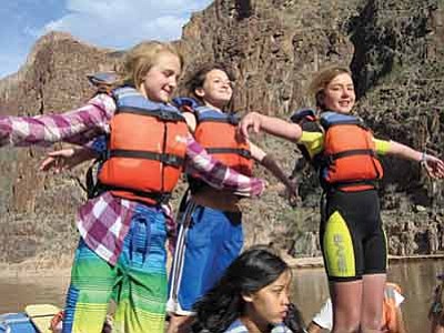 Three Grand Canyon Middle School students “take flight” while rafting down the Colorado River during a four day Grand Canyon Youth trip to the inner rim. Submitted Photo