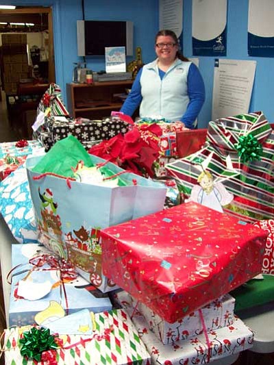 Delaware North Assistant Manager Carrie Putz stands with some of last year’s angel gifts. Submitted photo<br /><br /><!-- 1upcrlf2 -->