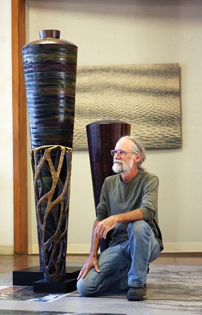 Wood sculptor and carpenter Michael Bauermeister with several of his scuplures. Loretta Yerian/WGCN