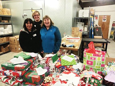 Local volunteers Grace Conklin, Alberta Saveedra & Goldie Pounds volunteer during last year’s angel tree and community food basket program. Photo/ Carrie Putz.